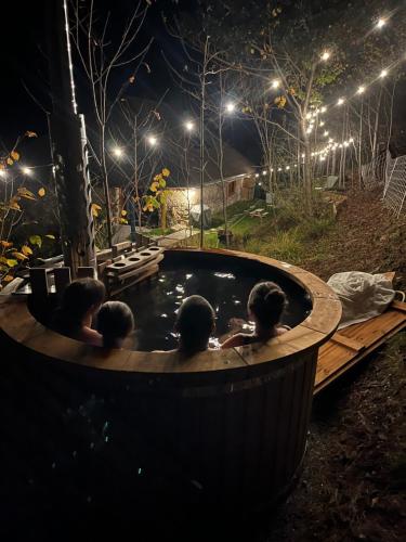 a group of people in a hot tub at night at Le Couleau in Chateauroux-les-Alpes