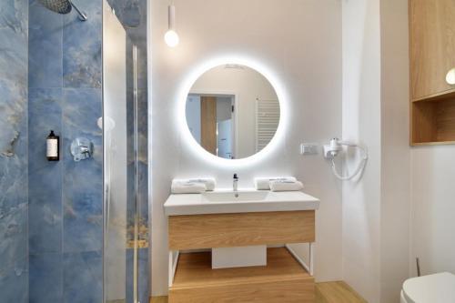 a bathroom with a sink and a mirror at Bel mare aqua 2 Aquapark in Międzyzdroje