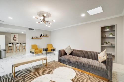 a living room with a couch and a table at Spectacular 4BR 2,5BA Holiday Home with Pool and Grill in Carrollton