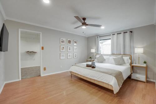 a white bedroom with a bed and a ceiling fan at Spectacular 4BR 2,5BA Holiday Home with Pool and Grill in Carrollton