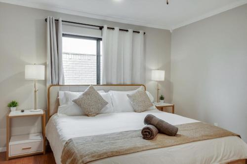 a bedroom with a large white bed with a window at Spectacular 4BR 2,5BA Holiday Home with Pool and Grill in Carrollton