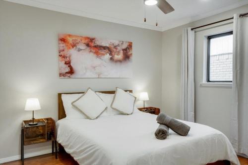 a white bedroom with a bed and a window at Spectacular 4BR 2,5BA Holiday Home with Pool and Grill in Carrollton