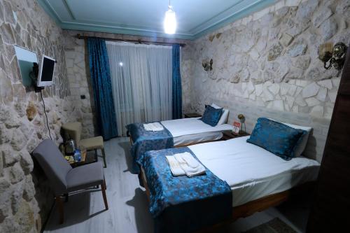 Кровать или кровати в номере KEMAL STONE HOUSE HOTEL.
