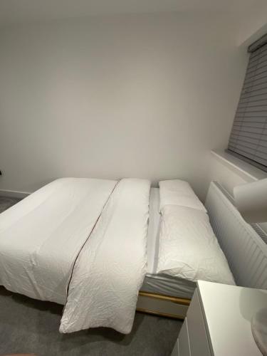 a white bed in a room with a window at Winter double bedroom in Stone Grove