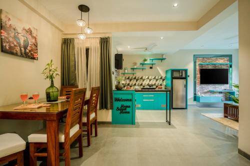 a kitchen and dining room with a table and chairs at G S Stay, 2BHK Luxury apartment Baga, Arpora, Goa in Arpora