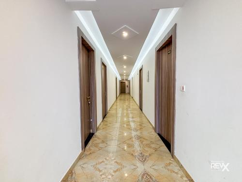 an empty corridor with white walls and floors and a long hallway at Raghuveer Sadan, Near Ram Mandir -10 Min Walk in Ayodhya