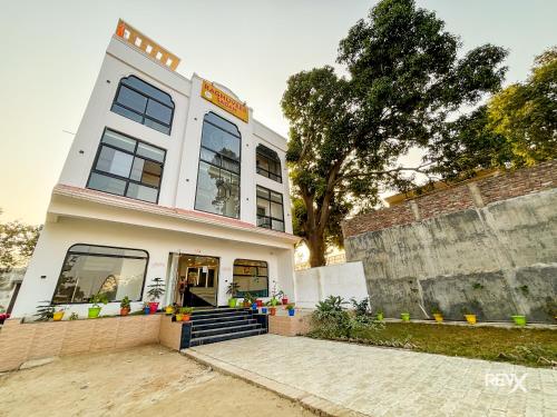 a white building with a staircase in front of it at Raghuveer Sadan, Near Ram Mandir -10 Min Walk in Ayodhya