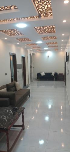 a living room with a couch and a table in a room at Gannet Alyousef City Center in Naj‘ al Maḩaţţah
