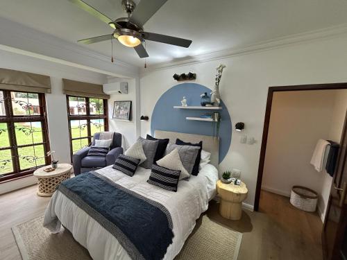 a bedroom with a bed and a ceiling fan at The Bryanston Boutique in Johannesburg