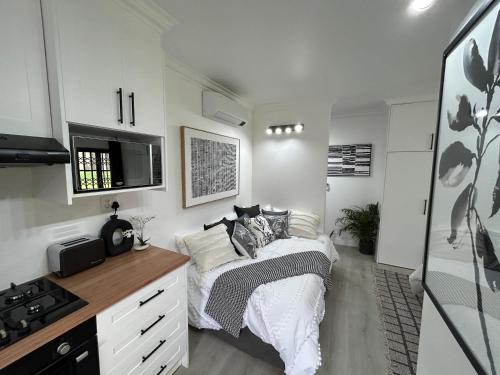 a bedroom with a bed and a stove in it at The Bryanston Boutique in Johannesburg