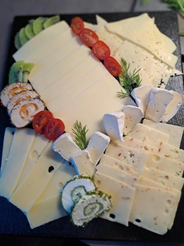 a plate of cheese and grapes on a table at Pension Alpenfeeling in Pfronten