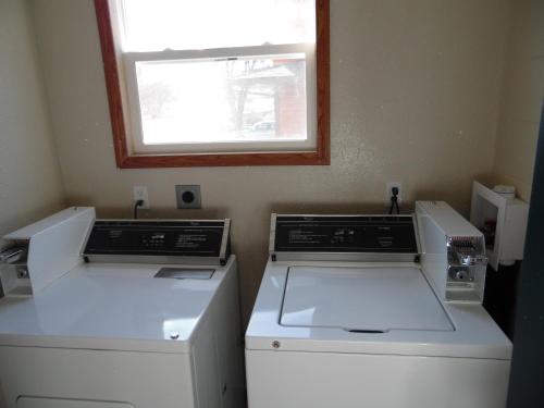 a kitchen with two appliances and a window at Bear Lodge Motel in Sundance