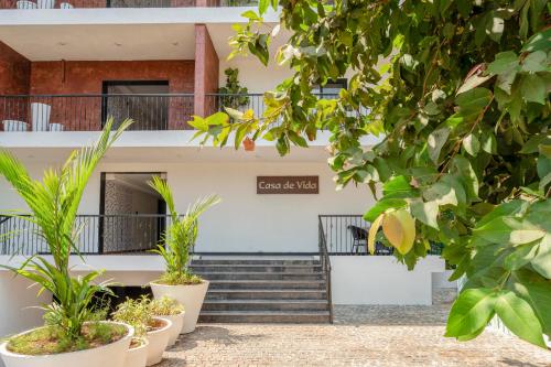a building with stairs and plants in front of it at G S Stay, 2BHK Luxury apartment Baga, Arpora, Goa in Arpora