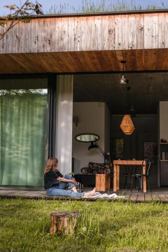a woman sitting on the porch of a house at Proste Chwile in Tylicz
