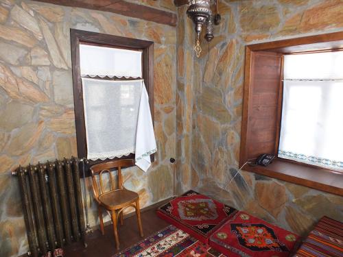 a room with a chair and a radiator and two windows at Sillehan Boutique Hotel in Konya