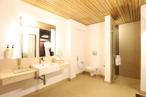 a bathroom with a sink and a toilet at The Chumbi Mountain Retreat & Spa, A Club Mahindra Associate in Pelling