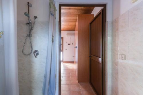 a bathroom with a shower and a shower curtain at Agriturismo Le Mimose in Arborea 