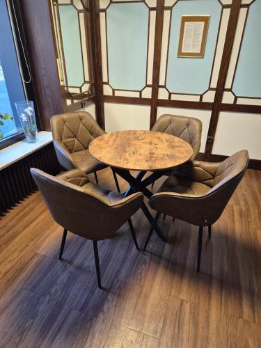 a table and two chairs in a room at Sure Hotel by Best Western Ambassador Duesseldorf in Düsseldorf