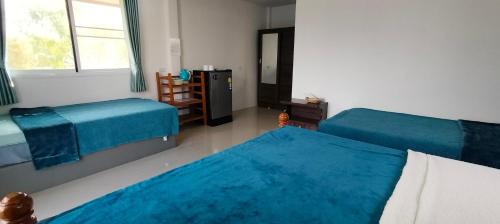 Ένα ή περισσότερα κρεβάτια σε δωμάτιο στο Poonsap Homestay