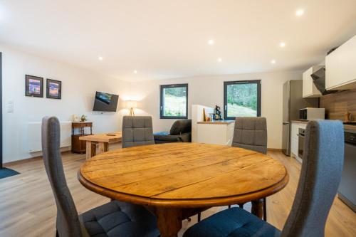 ein Esszimmer und eine Küche mit einem Holztisch und Stühlen in der Unterkunft Gîte pour 4 personnes - Le Grand Valtin, à 2 pas de Xonrupt in Ban-sur-Meurthe-Clefcy