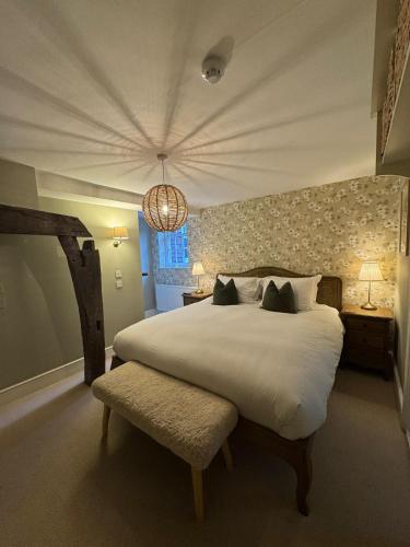 a bedroom with a large white bed and a window at The White Horse in Faversham