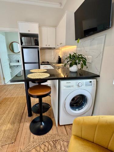 a kitchen with a washing machine and a counter at Casa Montanari in Cape Town