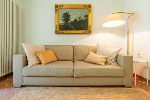 a couch with pillows on it in a living room at Origine Country Farm in Tabiano