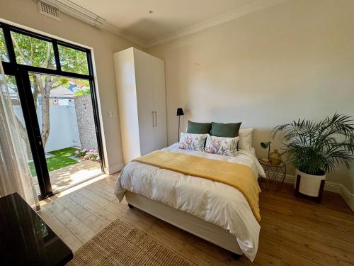 a bedroom with a bed and a large window at Casa Montanari in Cape Town