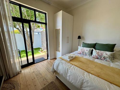a bedroom with a large bed and a large window at Casa Montanari in Cape Town
