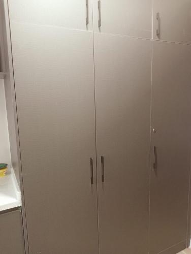 a pair of white cabinets in a kitchen at Nanic Homes Executive Studio in Marimbeti