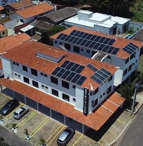 a building with solar panels on top of it at Hotel Silver in Rio das Pedras