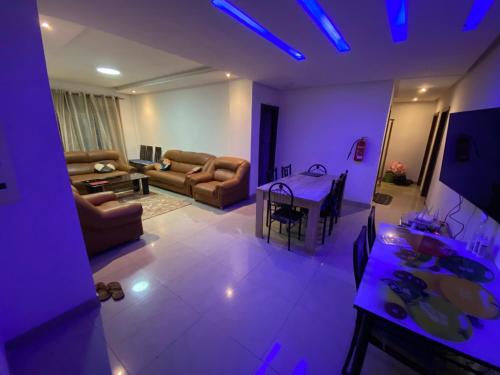 a living room with purple lights and a table at stay with sonu in Dakar