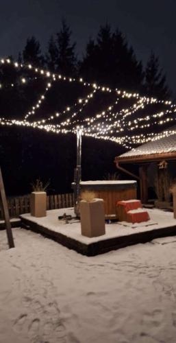 a patio with a lot of christmas lights at Doberek Noclegi w Beskidzie Niskim in Kobylanka