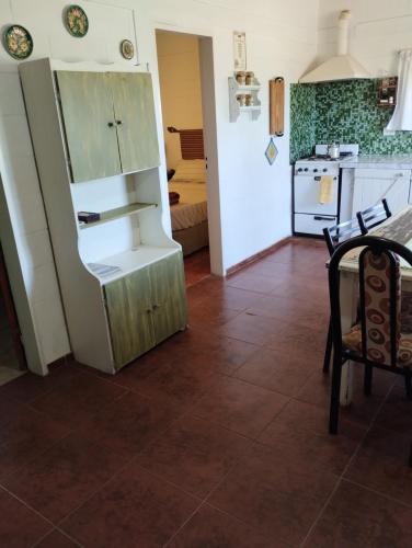 a kitchen with an open refrigerator in a room at Cabaña Villa del Dique, Calamuchita in Villa del Dique