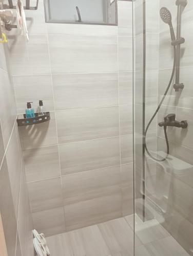 a bathroom with a shower with a glass door at Nanic Homes Executive Studio in Marimbeti