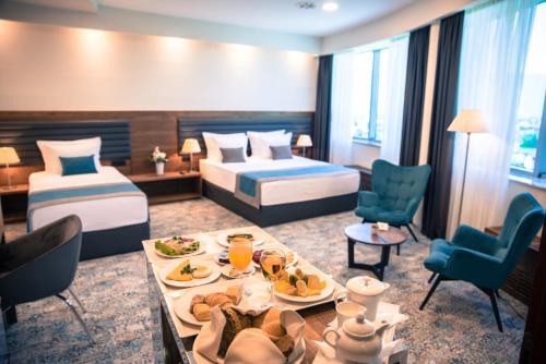 a hotel room with two beds and a tray of food at Radon Plaza in Sarajevo