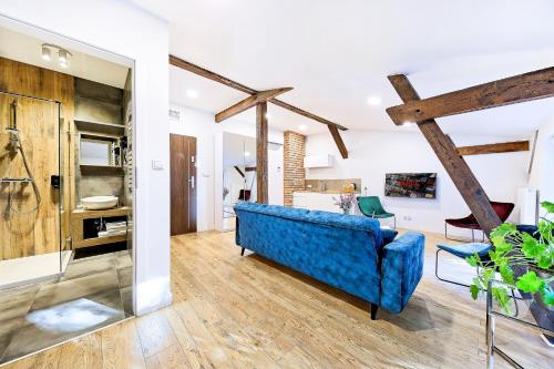 a living room with a blue couch and a table at Apartamenty Cinema in Poznań