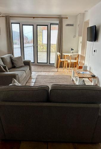 a living room with a couch and a table at The Haven in Portreath