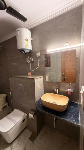 a bathroom with a sink and a toilet at Hotel Ivaan Homes opposite to Iskcon Temple East of Kailash New Delhi in New Delhi