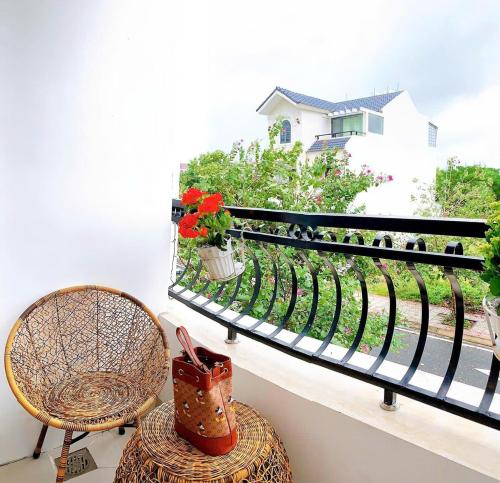 a balcony with a bench and a chair and flowers at Huy Hoàng Hotel in Xóm Cầu Hin