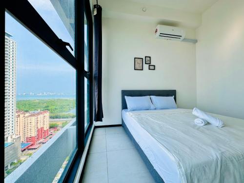 a bedroom with a bed and a large window at 3BR urban suites 8-10pax luxury family stay netflix in Jelutong