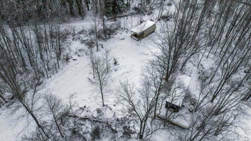 an aerial view of a snow covered field with trees at Modern Tiny Home Wraparound Deck in Great Valley