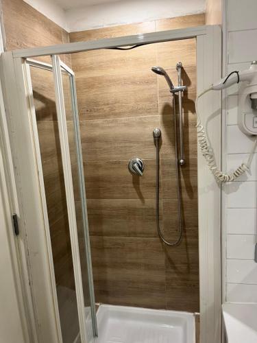 a shower with a glass door in a bathroom at The Fresh Glamour Accomodation in Naples