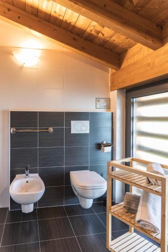 a bathroom with a toilet and a sink at Il Giardino Di Lory in Vercana