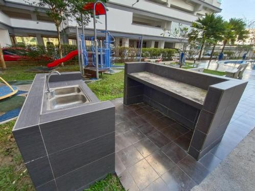 a concrete bench with a sink in a playground at Ehsan Residence KLIA Nilai , USIM, SEPAANG F1 Circuit, Xiamen University in Kampong Baharu Cheras Batu Sembilan