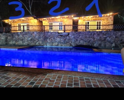 a swimming pool in front of a house at night at Casa Campestre la Martina in La Honda