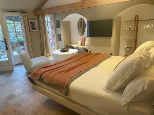 a bedroom with a large bed and a chair at Villa Louisa in Saint Malo