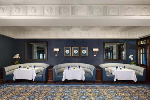a dining room with two tables and two chairs at Washington Duke Inn & Golf Club in Durham