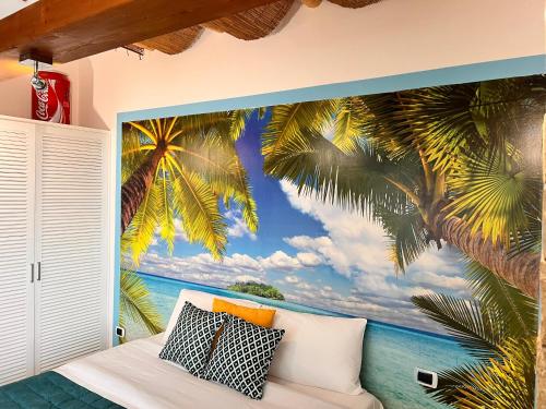 a bedroom with a mural of palm trees at Pompei Sunday Estate Exclusive Apartaments in Pompei