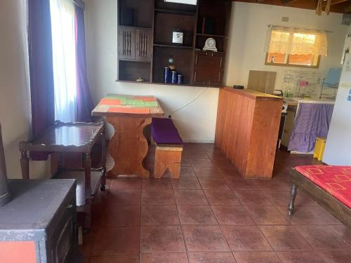 a kitchen with wooden tables and a counter in a room at Cabañas Costa Valdiviana in Valdivia